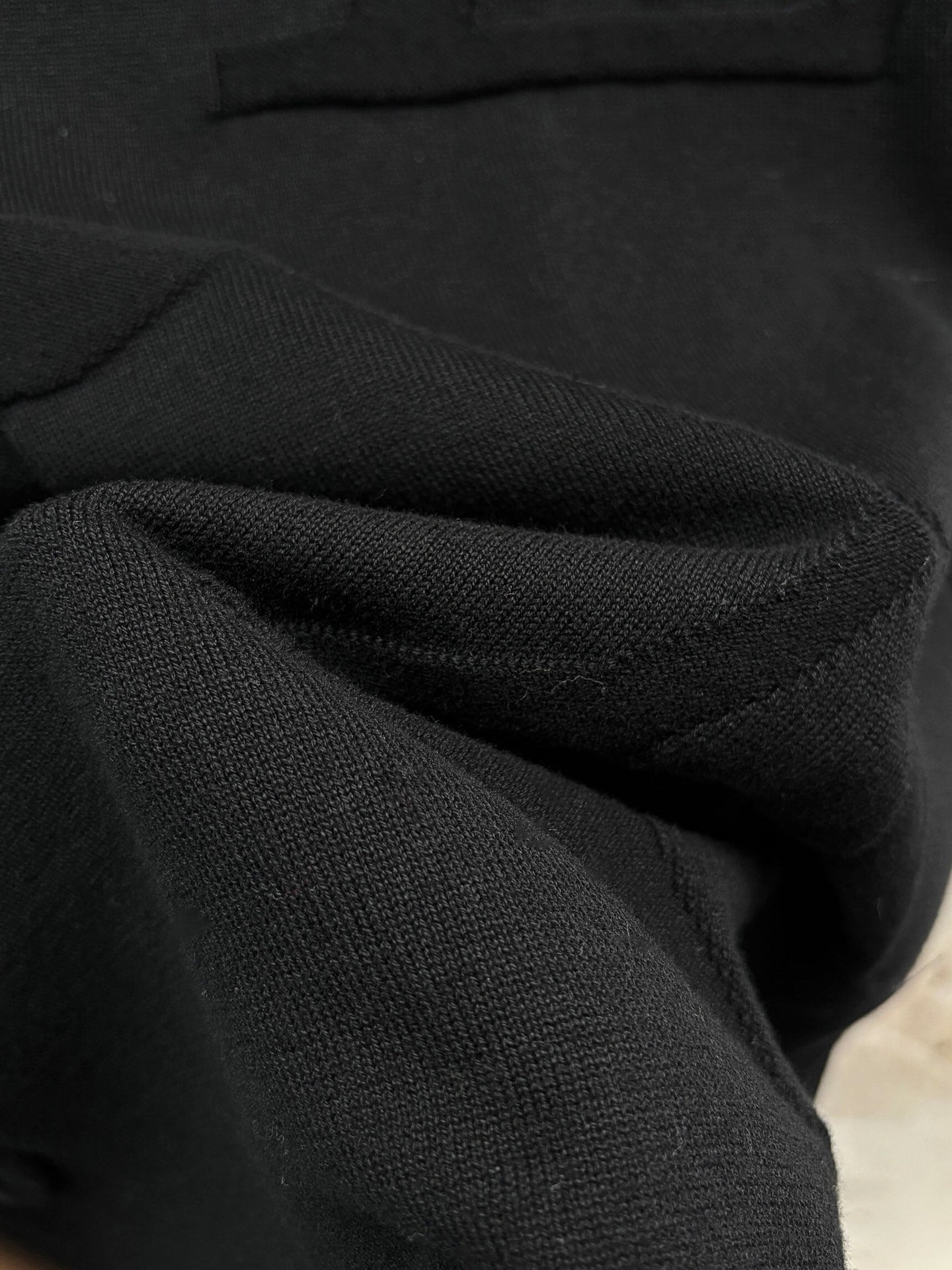 Louis Vuitton black knit fabric close-up from a short-sleeve shirt