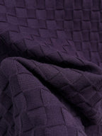 Purple textured knit T-shirt fabric close-up with woven square pattern