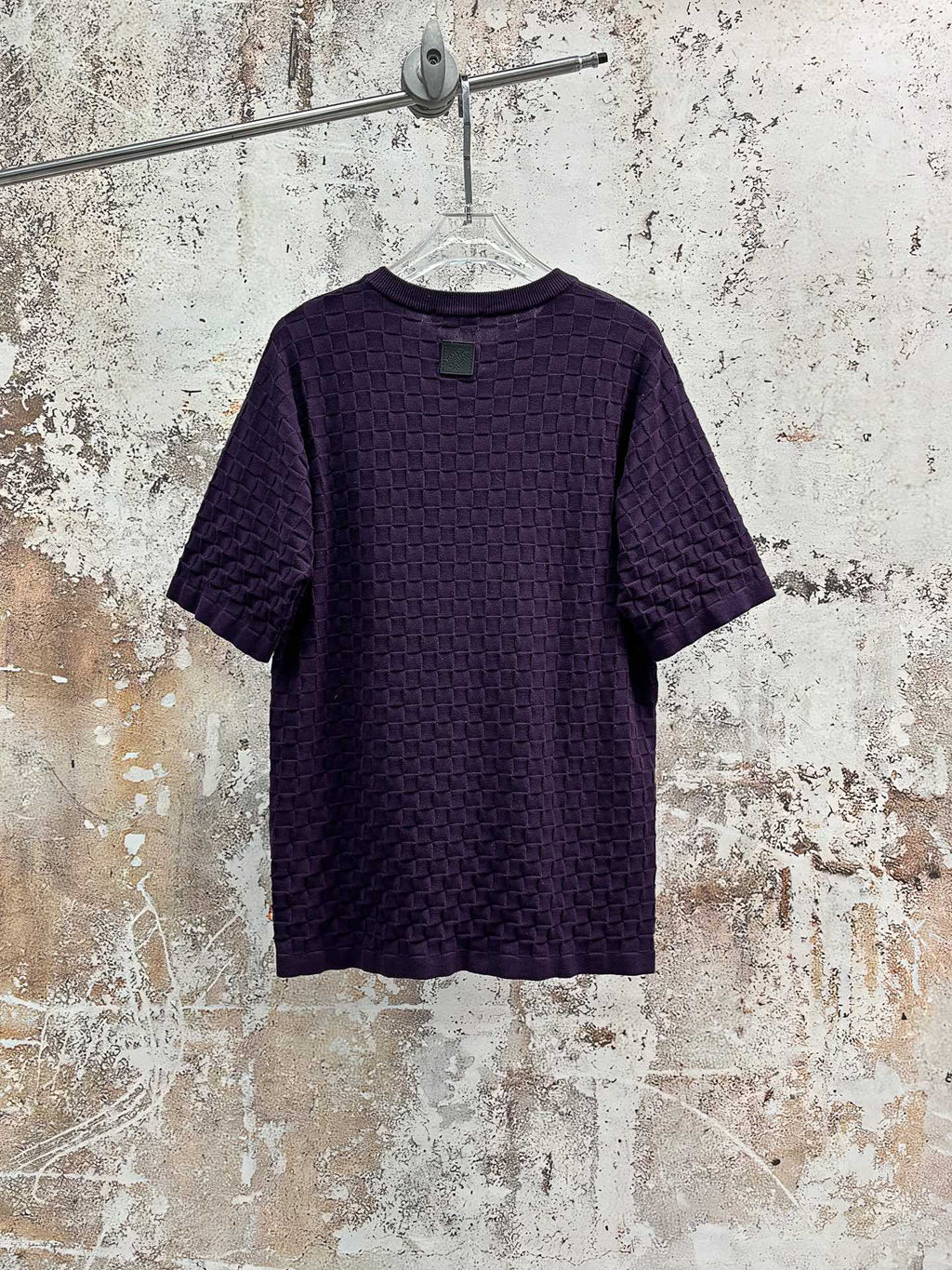 Purple textured knit crewneck T-shirt, back view on hanger