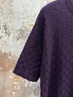 Purple textured knit T-shirt angled view of sleeve and side drape