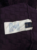 Purple textured knit T-shirt care label on interior neck seam