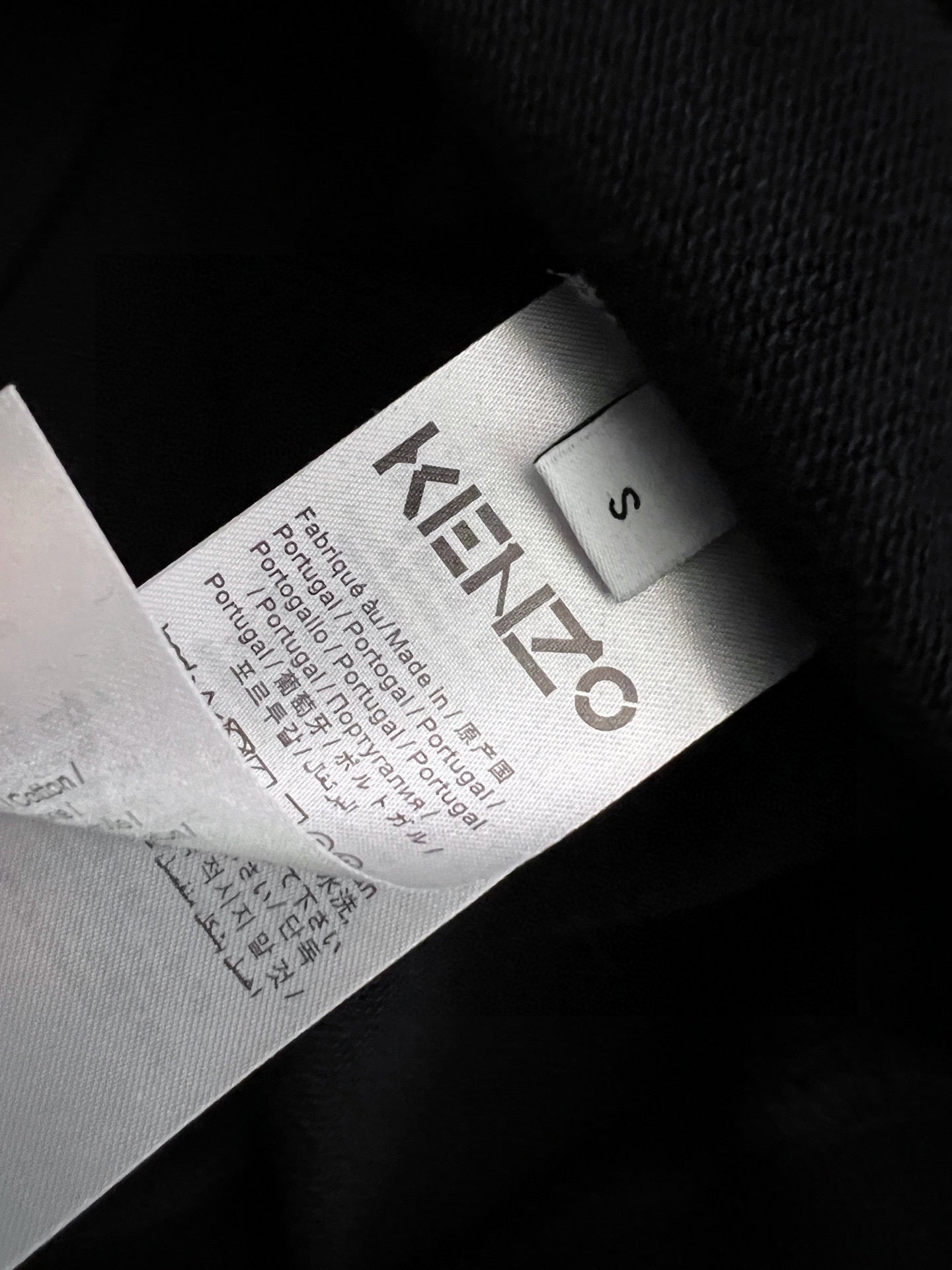 Black sweatshirt neck label with "KENZO" text and size markings
