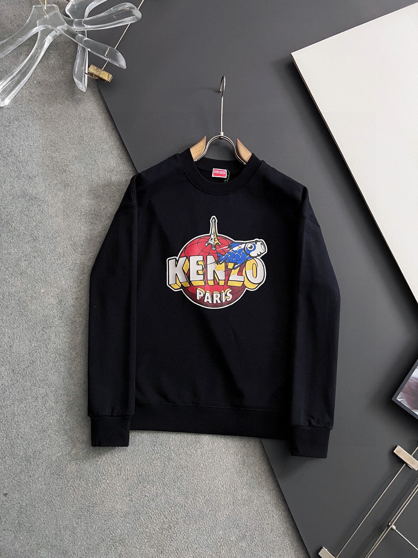 Black sweatshirt with colorful "KENZO PARIS" graphic on the chest
