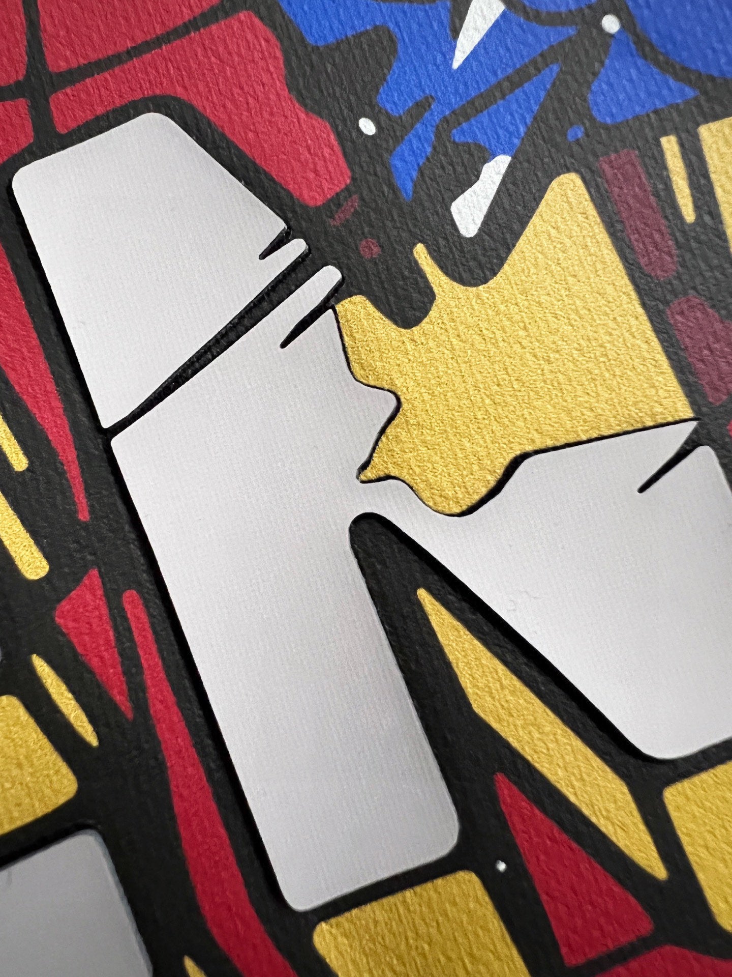 Multicolor graphic print detail on a black sweatshirt fabric