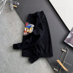 Black sweatshirt with "KENZO PARIS" graphic, folded on a hanger