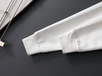 White sweatshirt sleeve and ribbed cuff detail