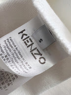White sweatshirt fabric with Kenzo size label and care text on interior tag