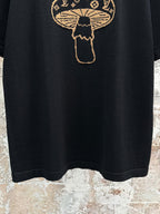 Black short-sleeve T-shirt hem with gold embroidered mushroom emblem graphic
