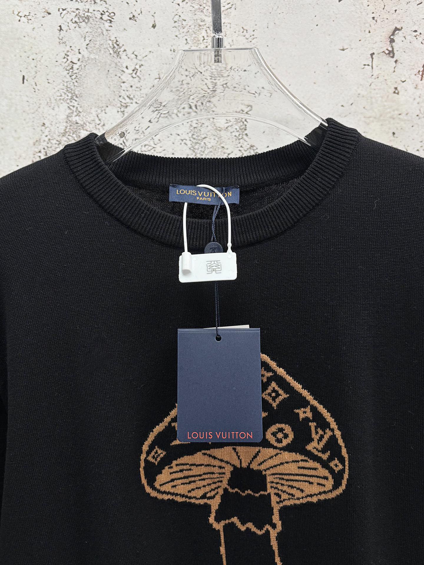 Black T-shirt with gold embroidered mushroom emblem and hanging garment tags