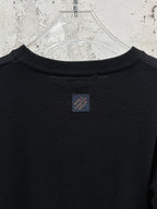 Black crew-neck T-shirt with small brand tag at back collar