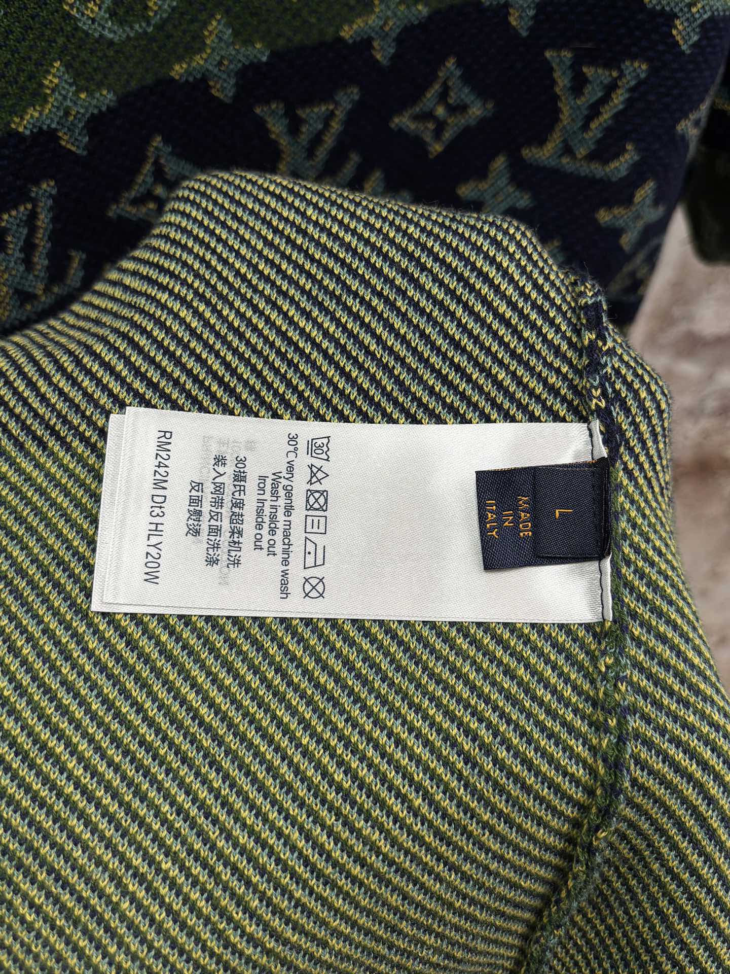 Inside neck label on short-sleeve knit shirt with care and size text tag