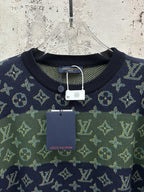 Crewneck short-sleeve shirt hanging on hanger with navy and green monogram pattern