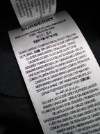 Burberry care label on inside waistband showing fabric composition and care instructions