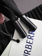 Burberry branded fabric tag with blue logo text