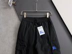 Black cargo pants on hanger, elastic waistband with drawstring and side cargo pockets