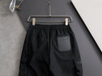 Black cargo pants with elastic waistband and drawstring, with side pocket detail