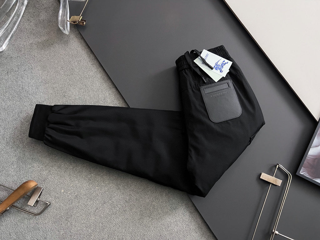 Black cargo pants with elastic waistband, drawstring, and multiple pocket details