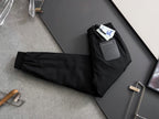 Black cargo pants with elastic waistband, drawstring, and multiple pocket details