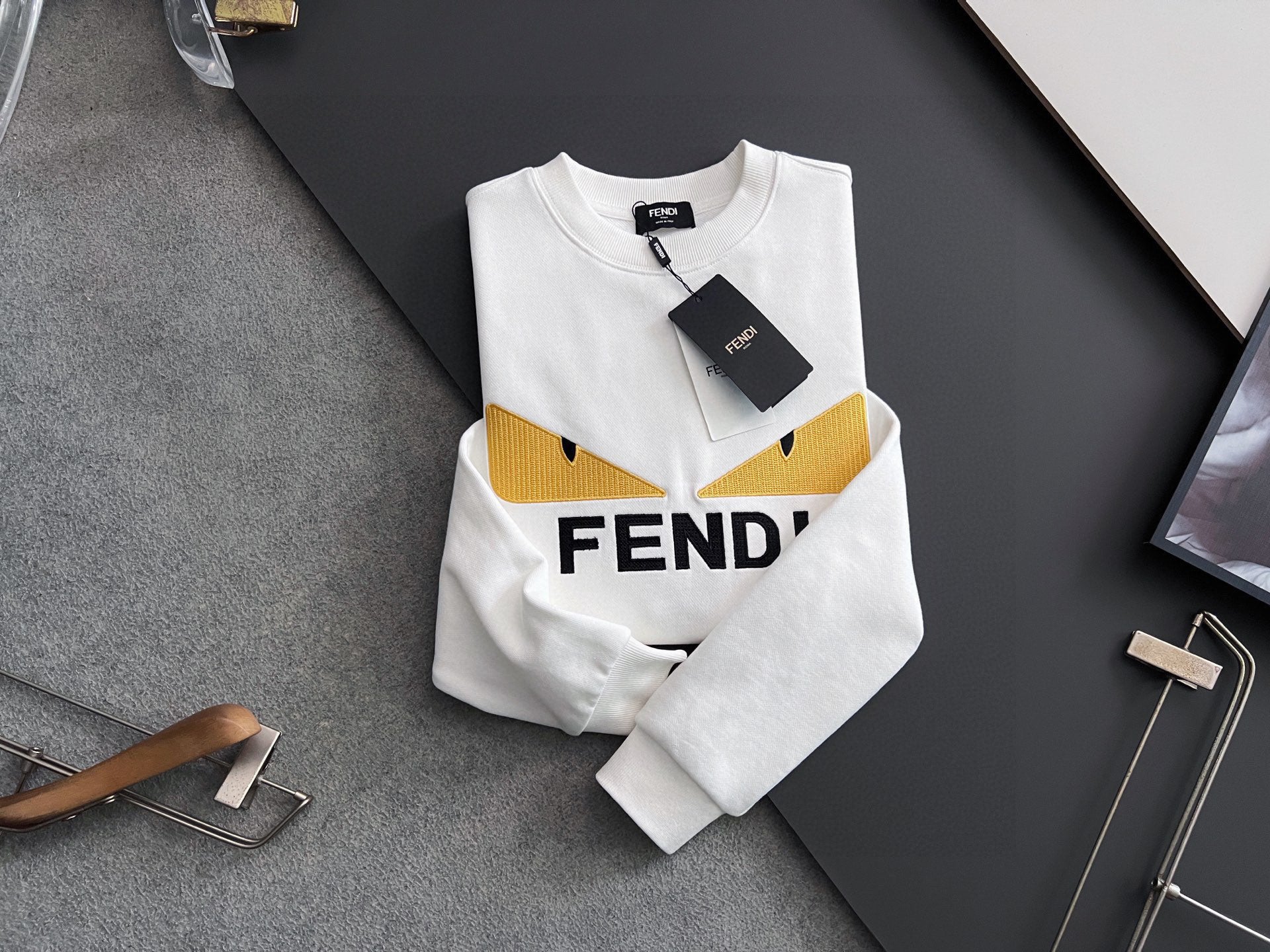 White long-sleeve sweatshirt with yellow logo band and FENDI wordmark, tag attached