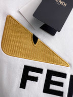 White sweatshirt sleeve with yellow embroidered V detail and black FENDI letters