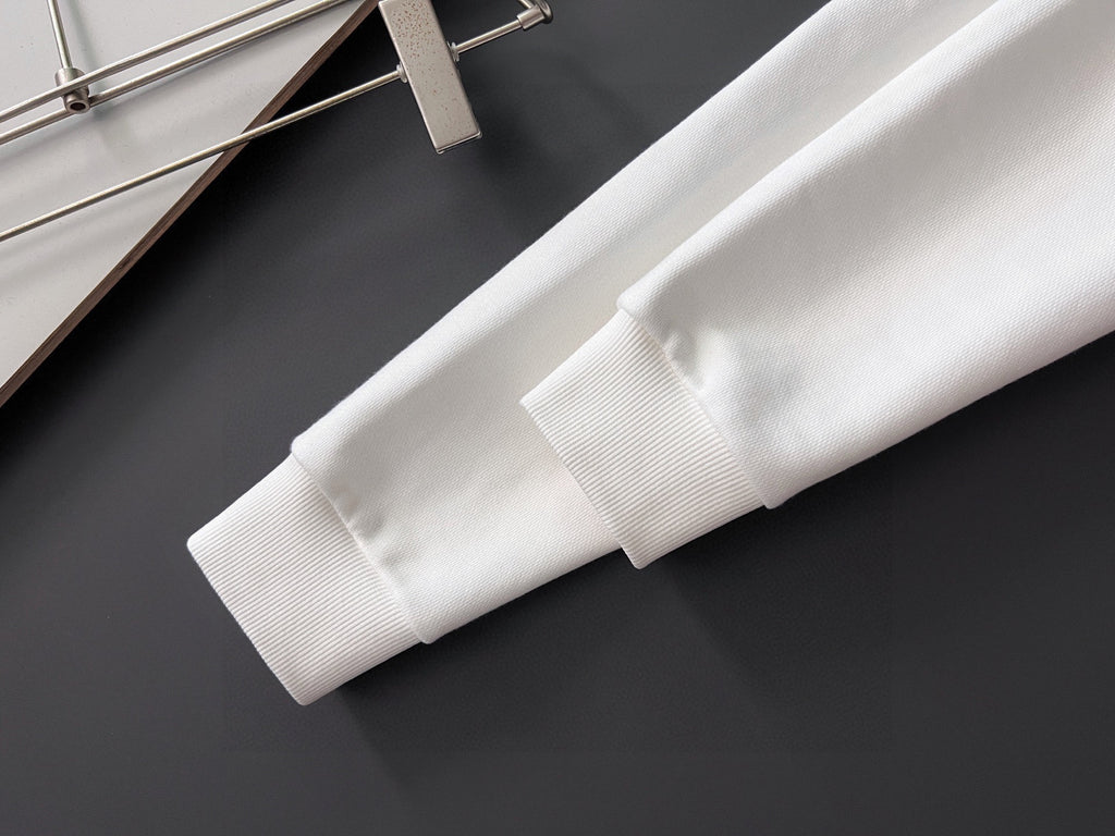 White sweatshirt sleeve cuff with ribbed hem and stitched seam detail