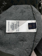 Textile care label on dark green knit T-shirt with blue-and-white logo fabric