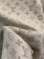 Beige monogram knit fabric with soft texture and patterned weave