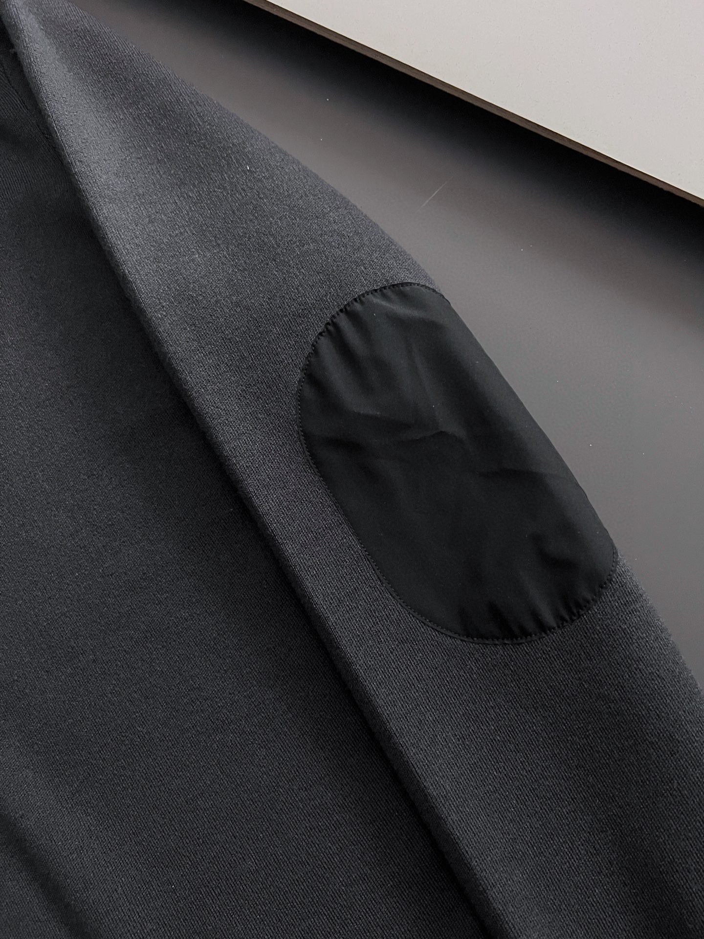 Prada long-sleeve top, black, close-up of gathered sleeve detail
