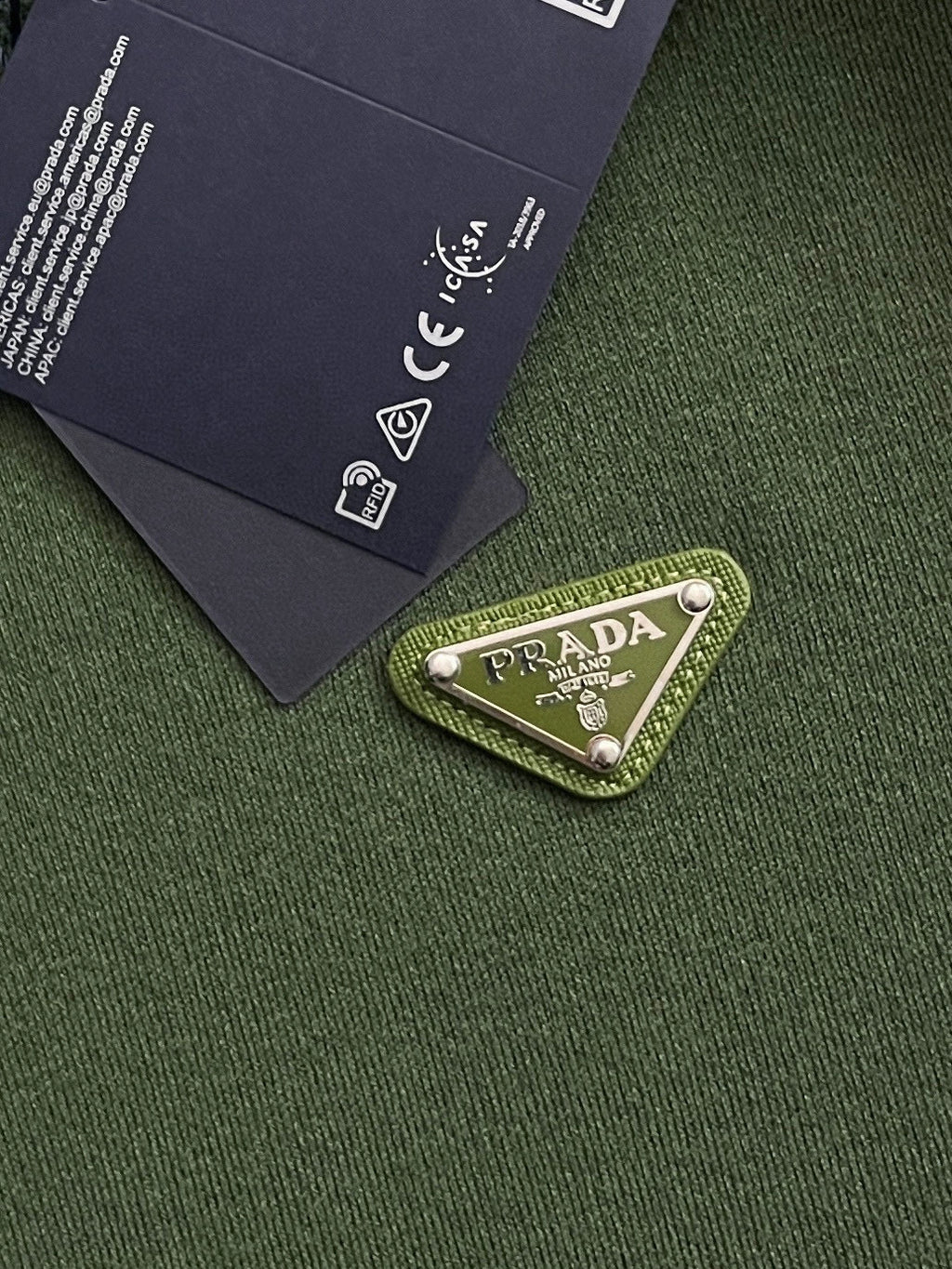 Green knit fabric with PRADA logo patch label