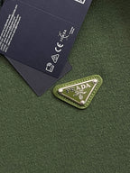 Green knit fabric with PRADA logo patch label