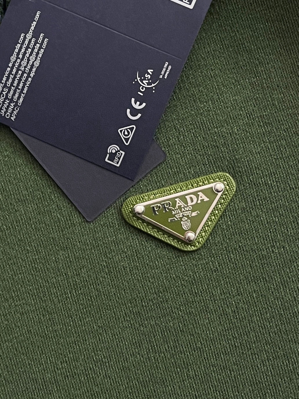 Green knit fabric with PRADA logo patch label