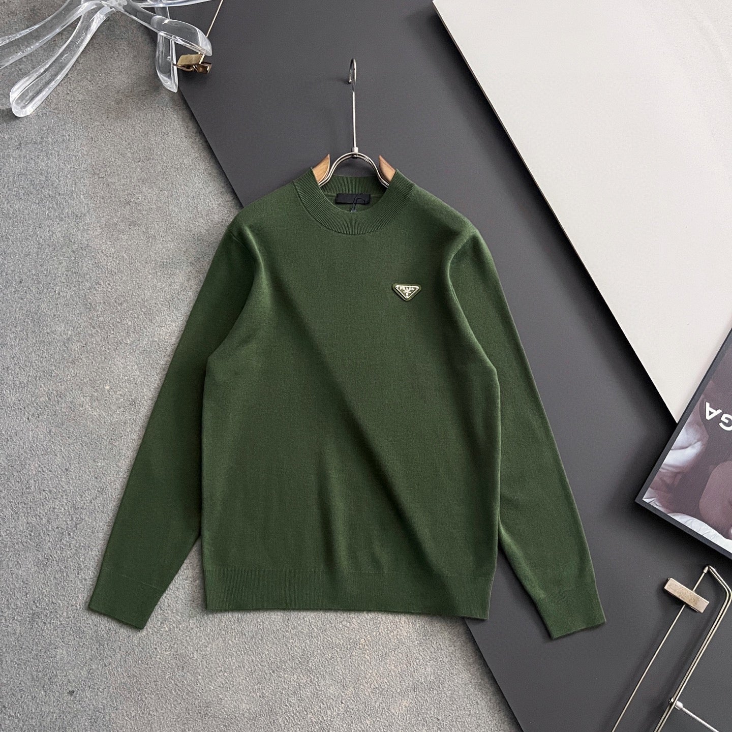 Green knit sweater with ribbed collar, long sleeves, and Prada triangular chest logo