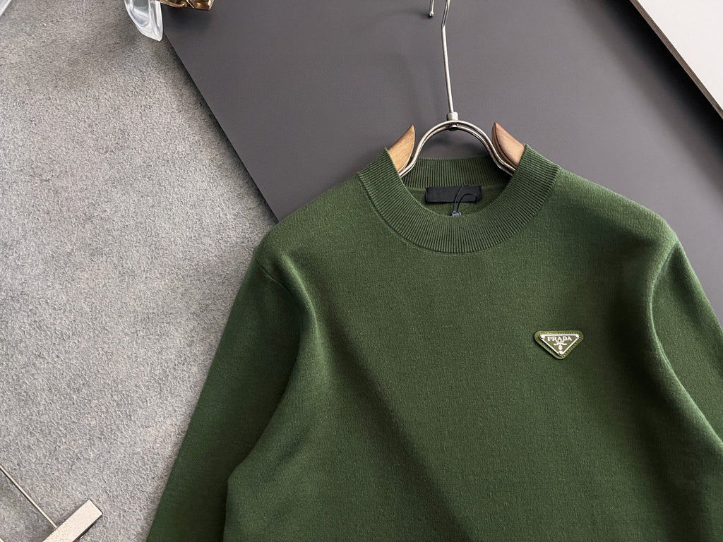 Green knit sweater with ribbed crew neck and small Prada triangular chest logo
