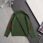 Green knit sweater with long sleeves, ribbed collar, and brown elbow patches