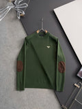 Green knit sweater with long sleeves, ribbed collar, and brown elbow patches
