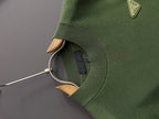 Green knit sweater neckline and ribbed cuffs with inner neck label