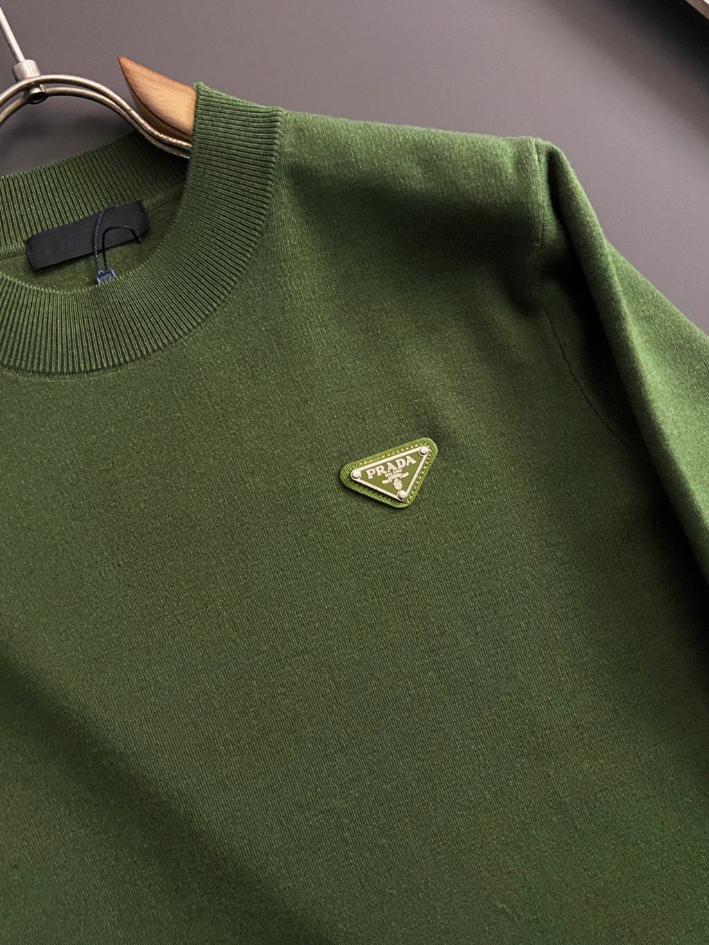 Green knit sweater with Prada triangular chest logo on the upper front