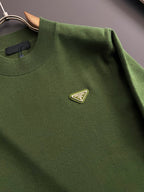 Green knit sweater with Prada triangular chest logo on the upper front