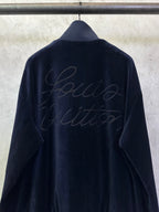 Dark navy zip-up jacket back view with subtle embossed cursive logo