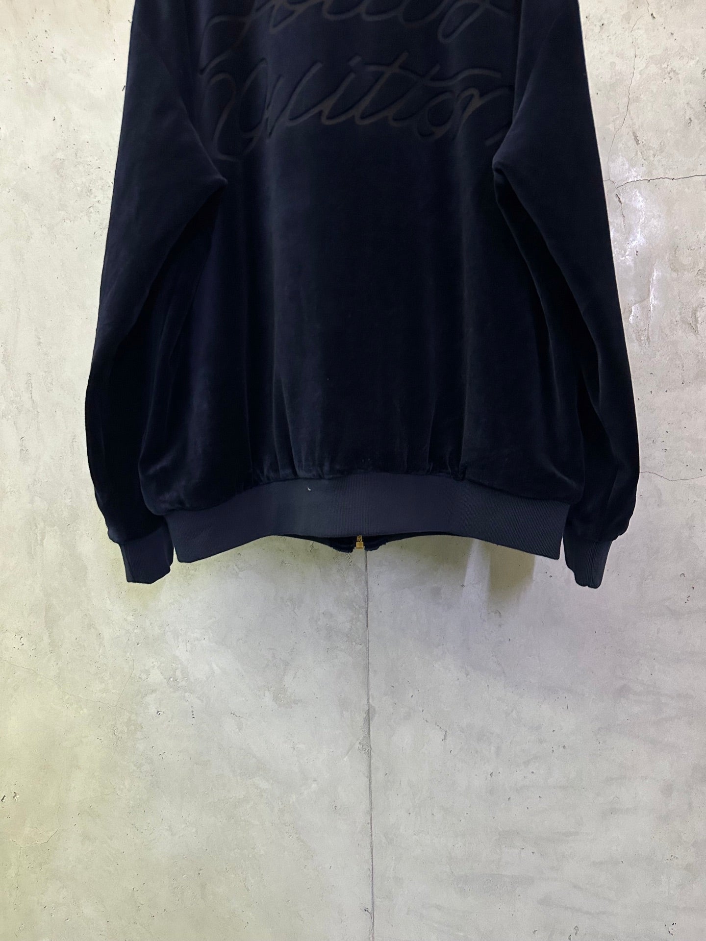 Dark navy zip-up jacket back view with ribbed hem and cuffs
