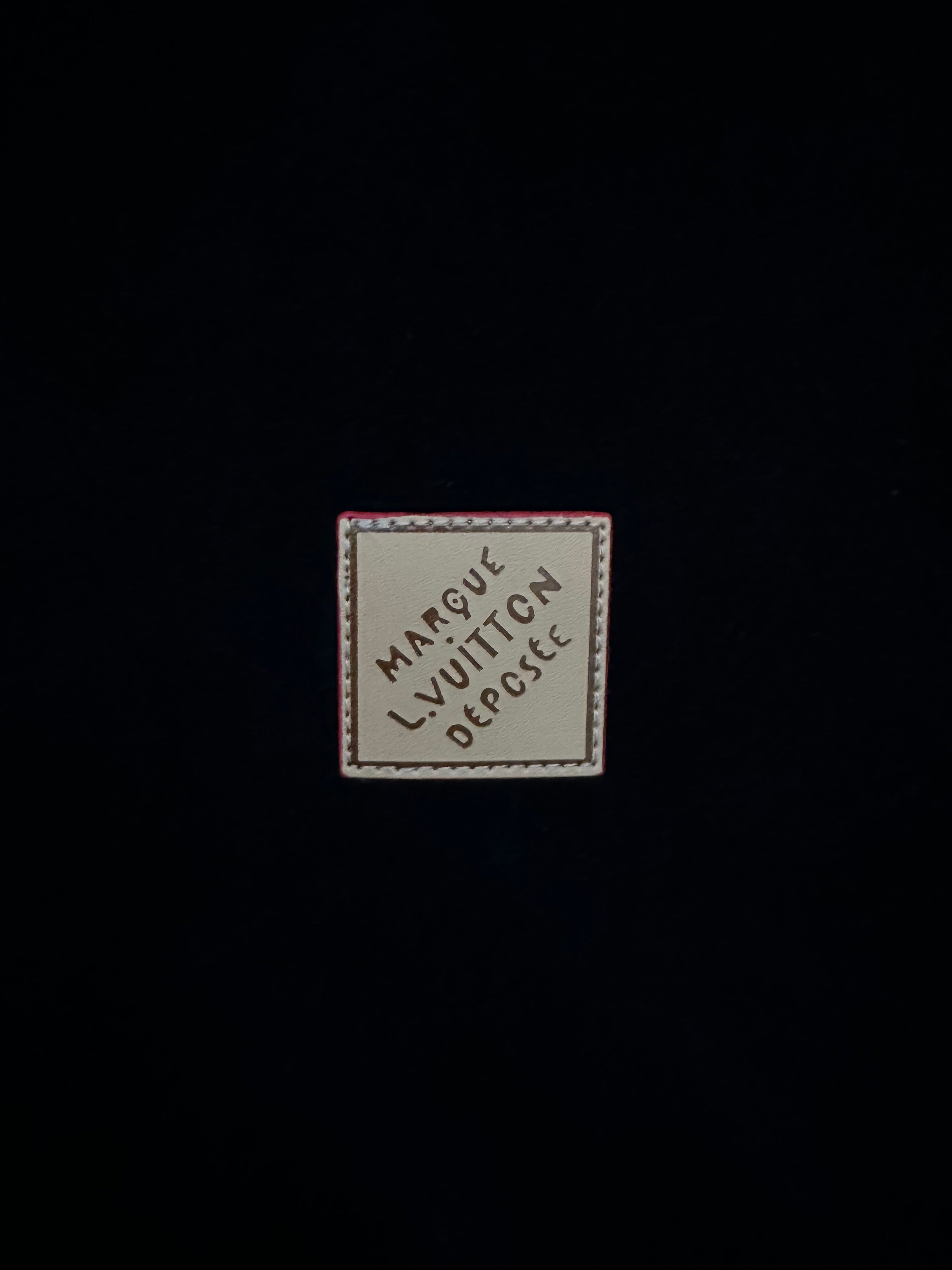 Garment label patch reading "Marque Vuitton" and "Depute"