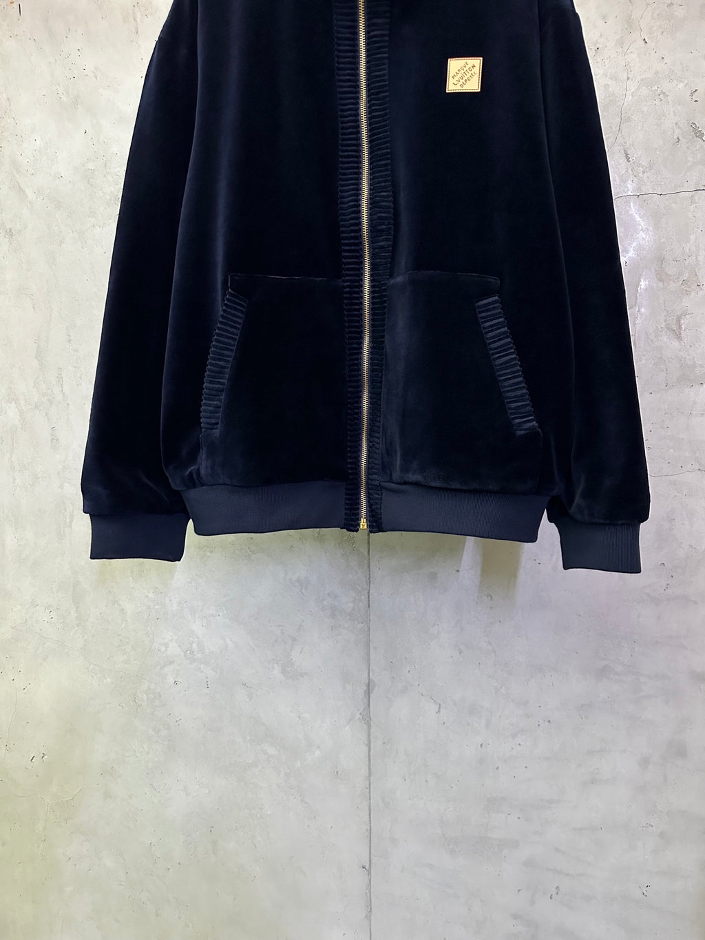 Dark navy zip-up jacket front view with large chest patch pockets