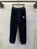 Navy drawstring pants with elastic waistband and gold-tipped cords