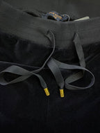 Navy waistband with drawstring cords and gold cord tips