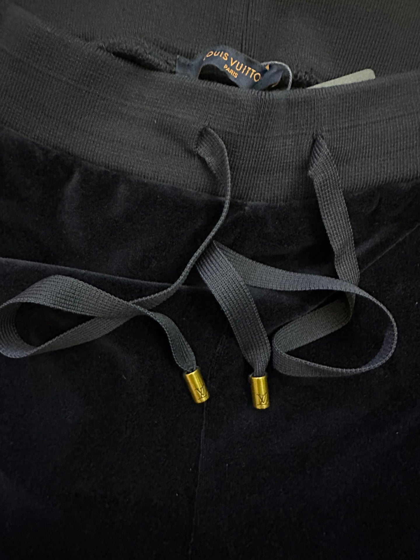 Navy waistband with drawstring cords and gold cord tips