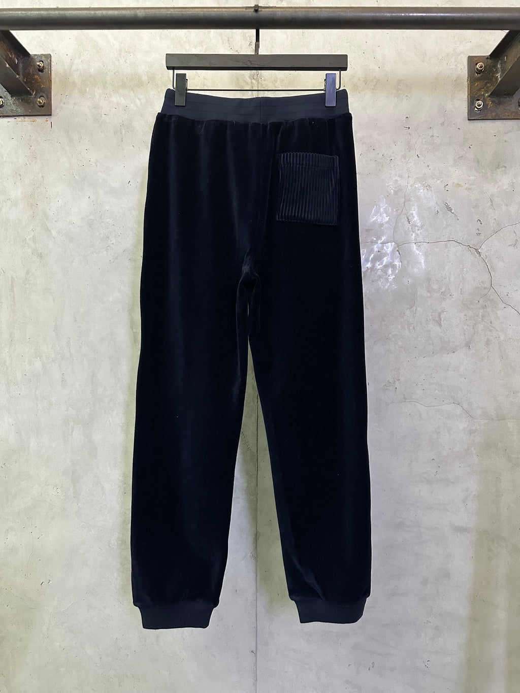 Dark navy pants with elastic waistband and front patch pocket
