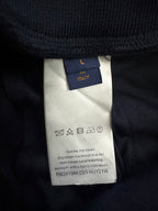 Navy pants care label with 'L in Italy' and cleaning instructions
