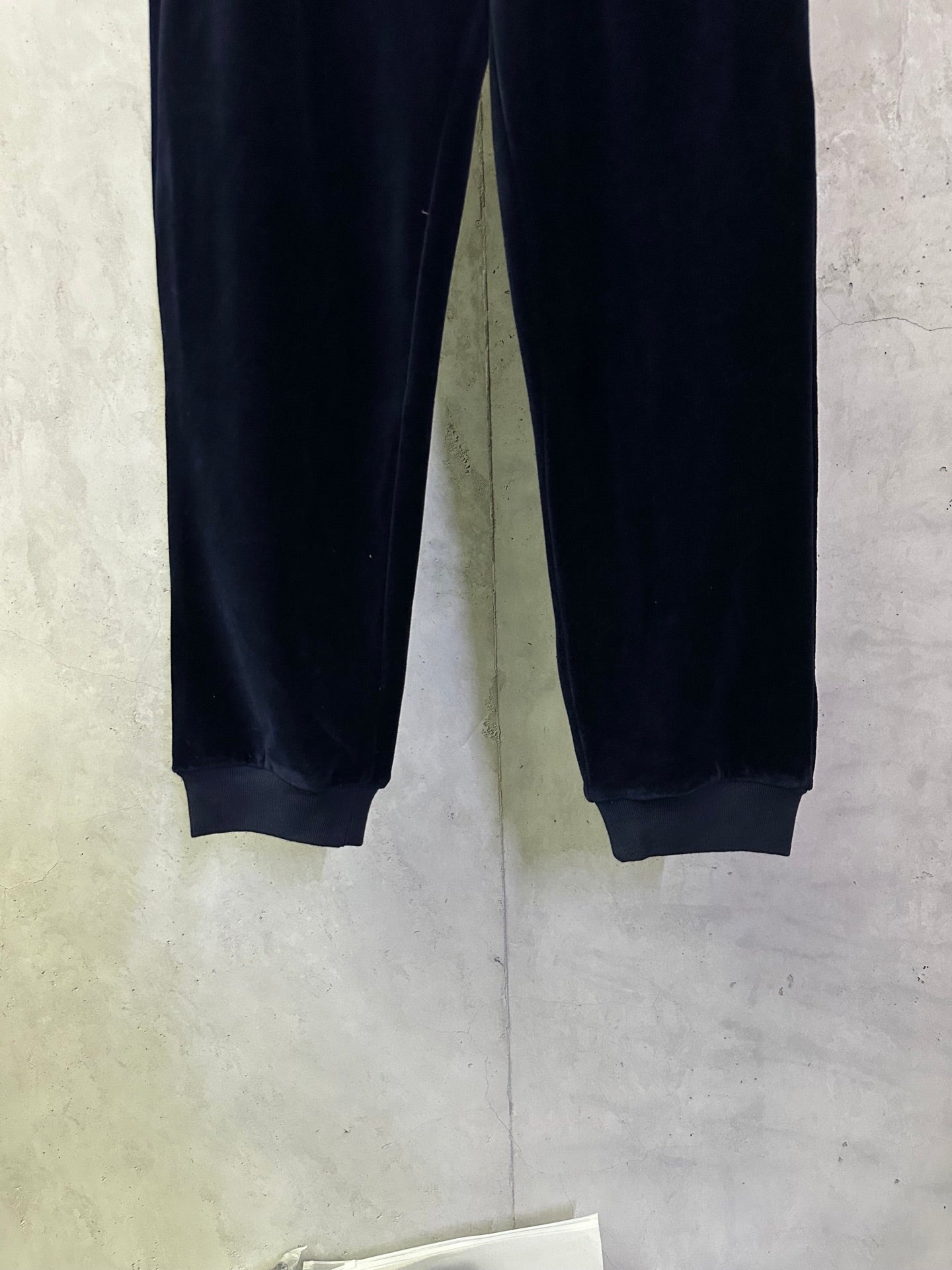 Navy straight-leg pants with elastic cuffs