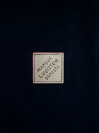 Rectangular logo patch on navy pants fabric