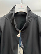 Moncler long jacket collar close-up with front zipper and Moncler logo patch